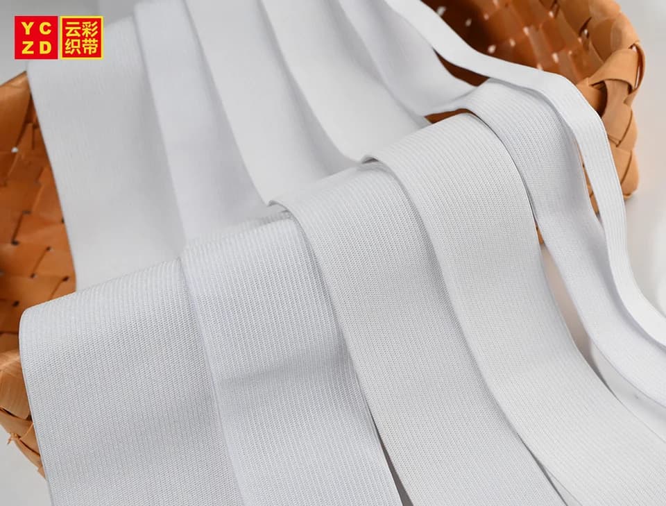 White ribbed elastic bands draped over a basket
