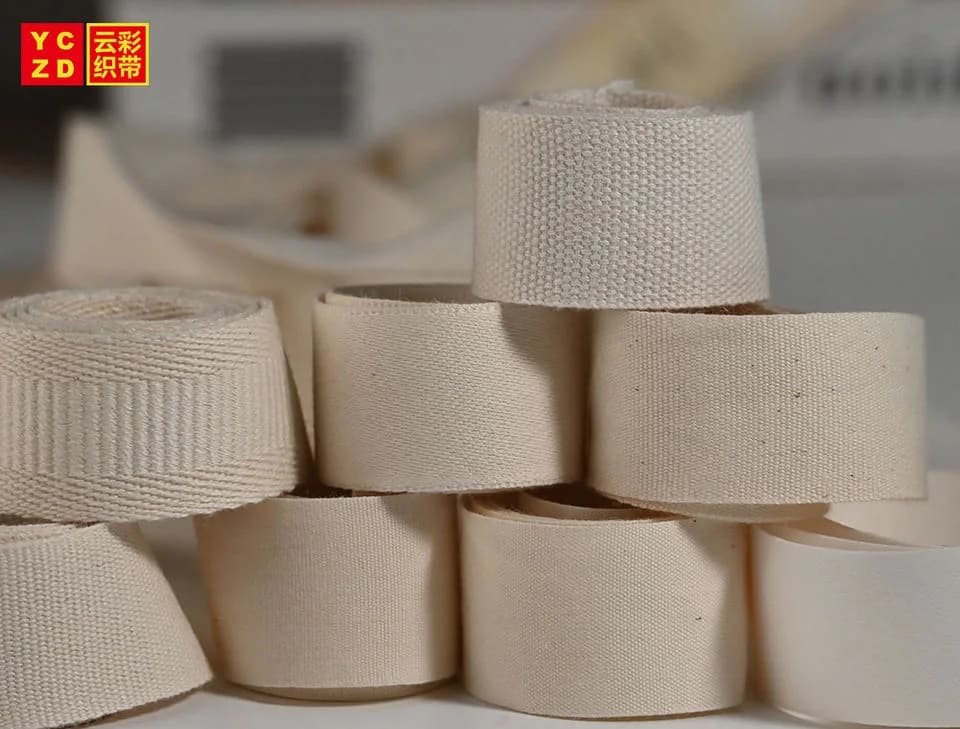 Cream webbing rolls stacked on a table