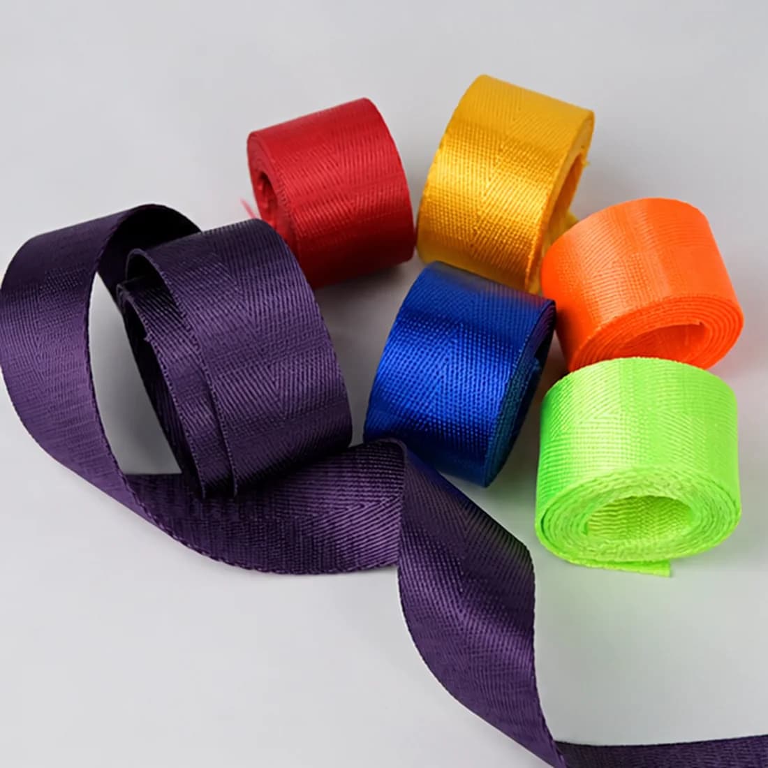 Real colorful woven webbing samples photographed for bag strap material selection
