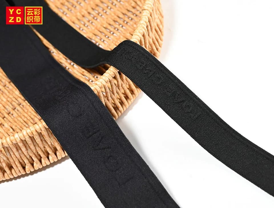 Black elastic bands draped across a woven basket
