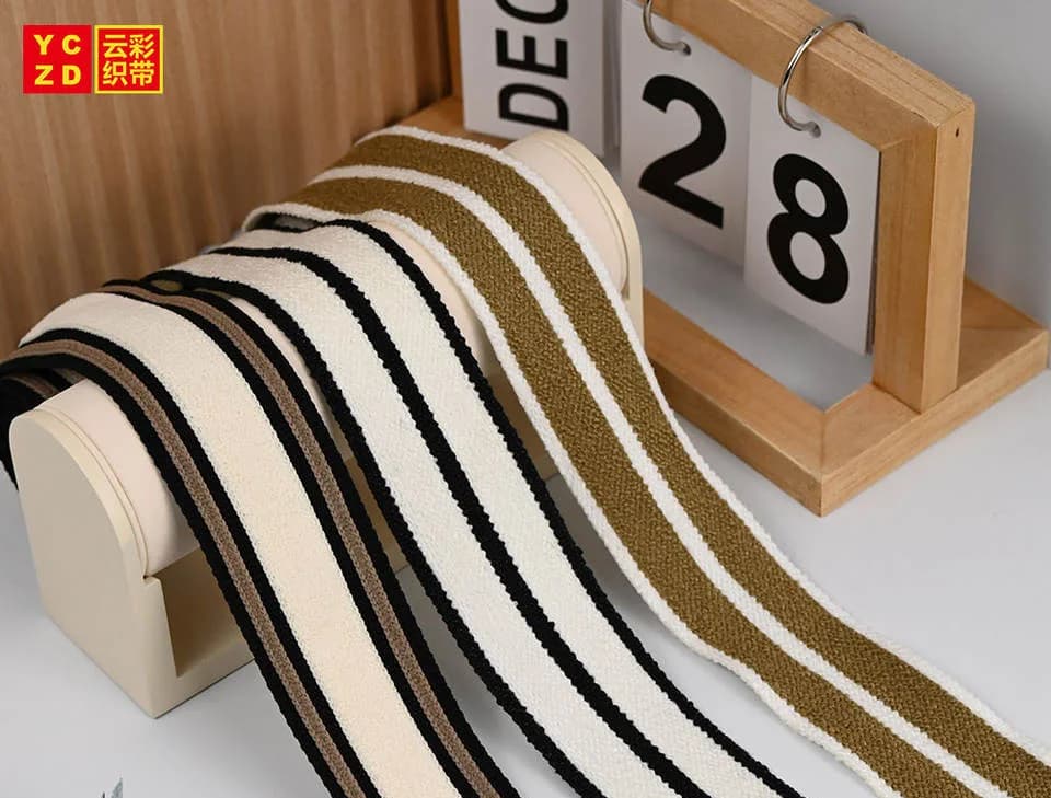 Cream tapes with black and brown parallel stripes on a display