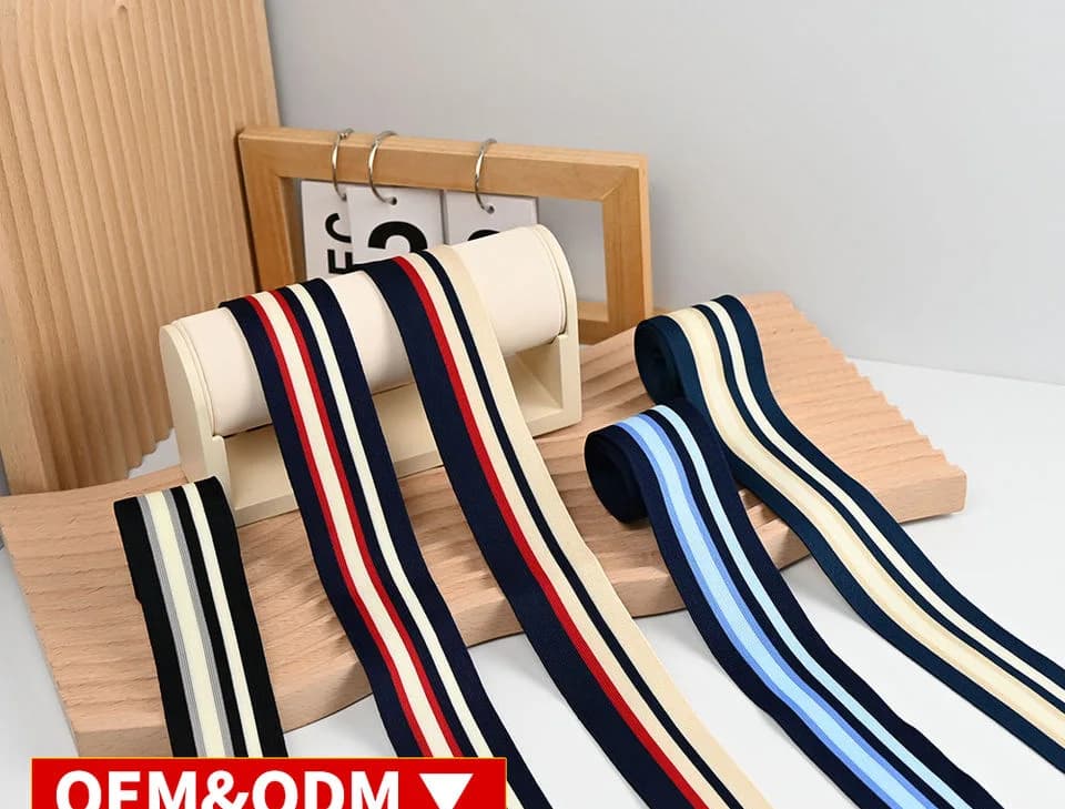 Navy, red and blue striped tapes draped over white display bars