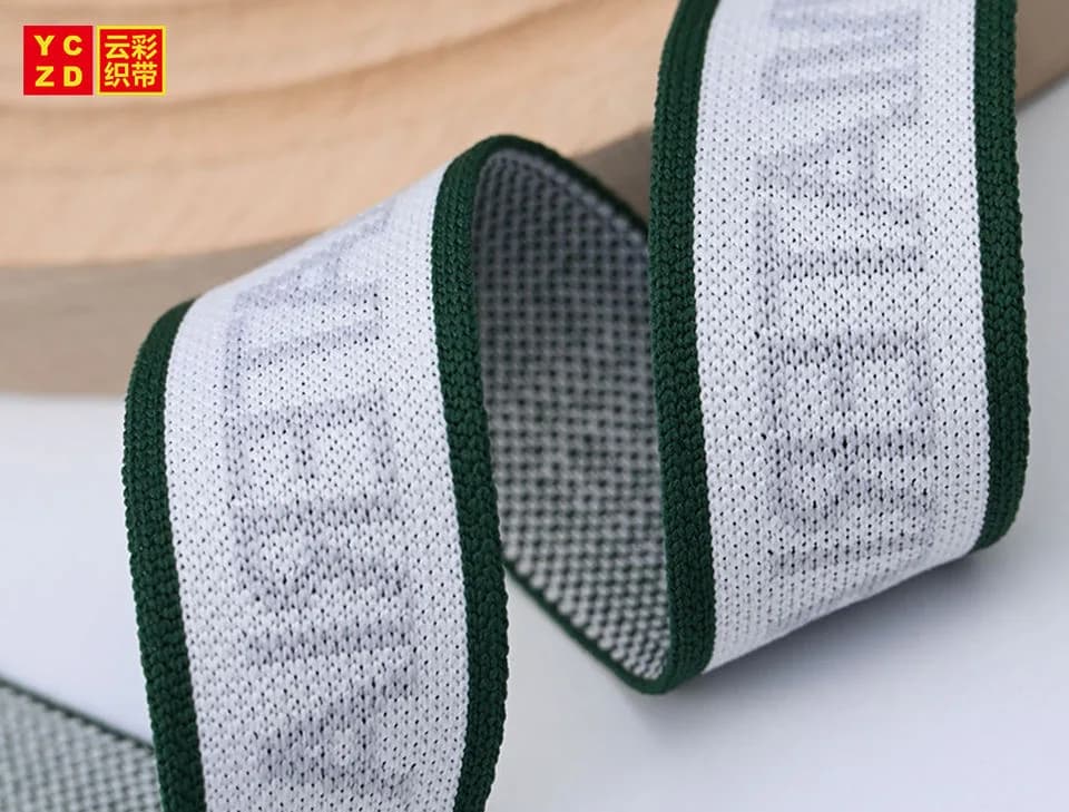 Pale jacquard tape with dark green borders curled into waves