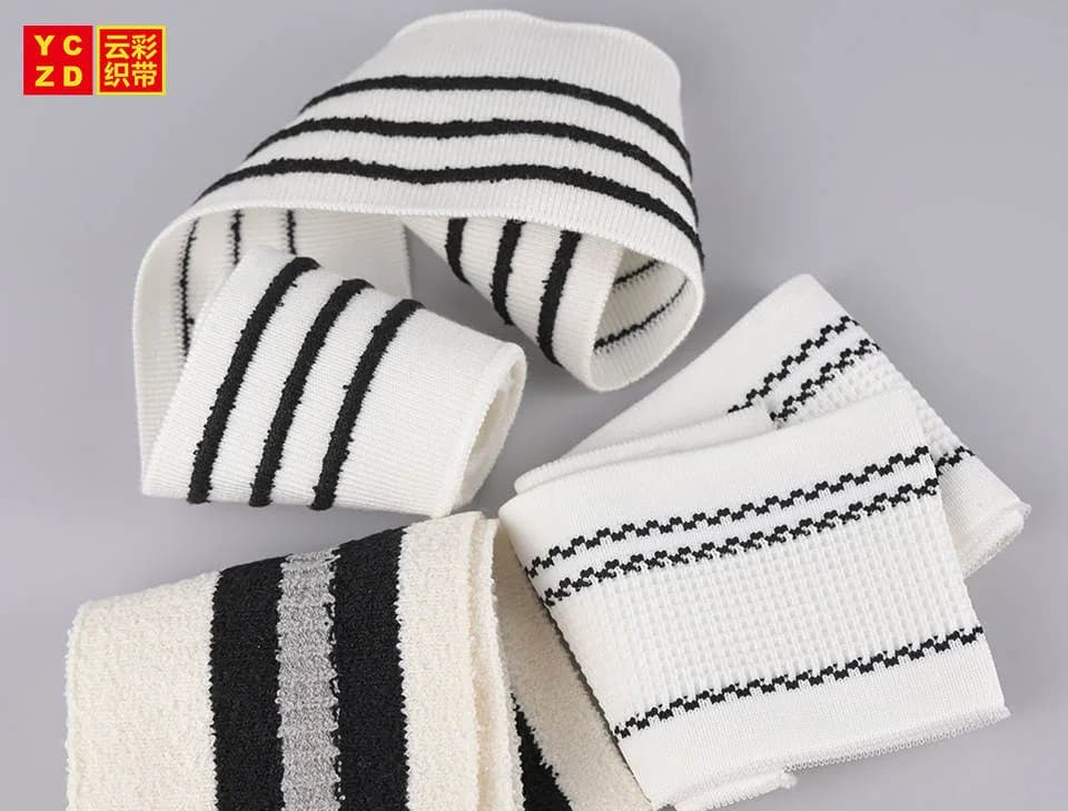 Cream rib-knit bands with black stripes folded into loops