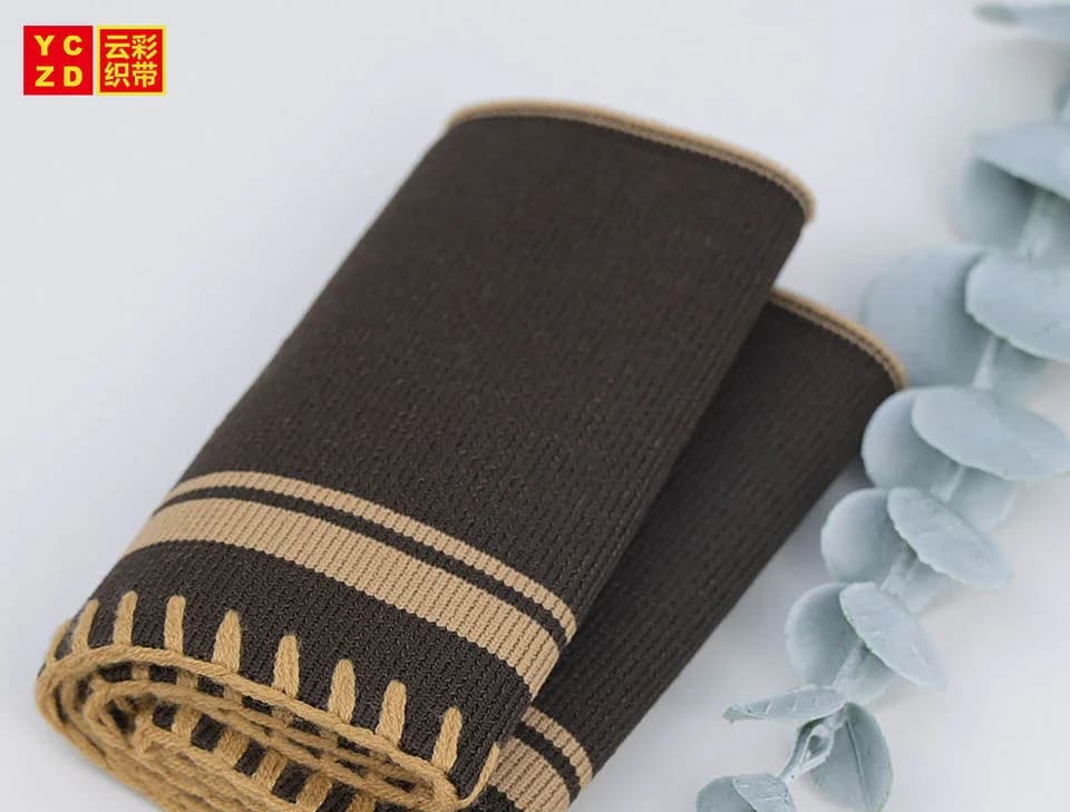Dark rib-knit trim with tan edge details curled into a roll