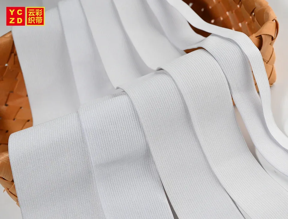 White ribbed elastic bands draped over a basket