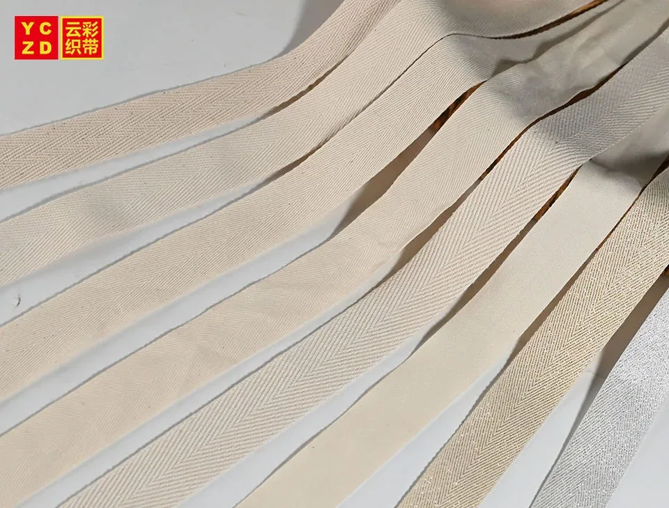 Cream woven tapes laid diagonally across a grey surface