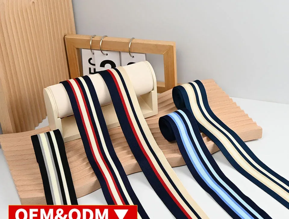 Navy, red and blue striped tapes draped over white display bars