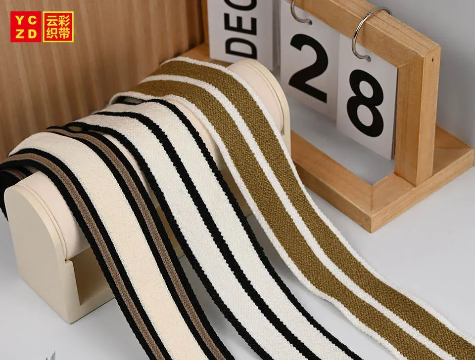 Cream tapes with black and brown parallel stripes on a display